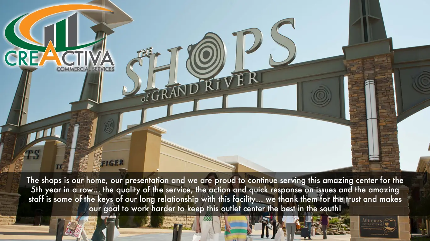 A large sign that says grand river shops.